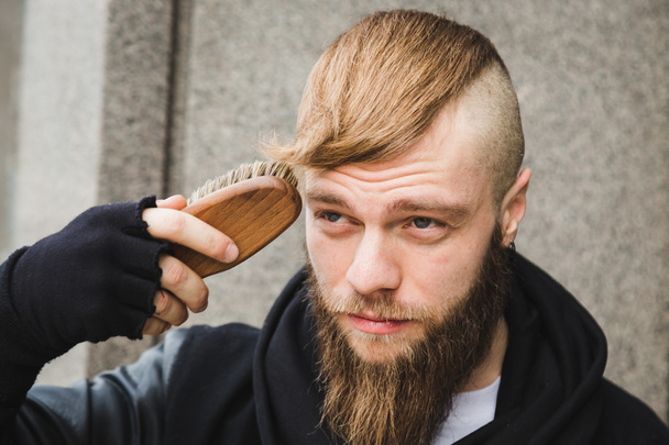 Stylish man brushing his hair - Fotoğraf, Görsel