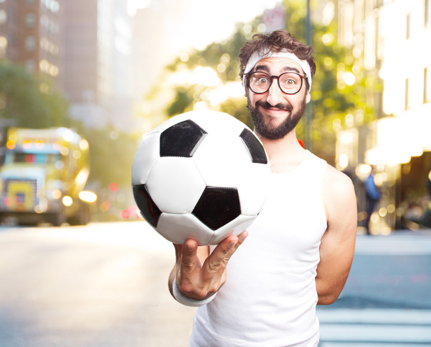 young crazy sportsman with football ball - 写真・画像