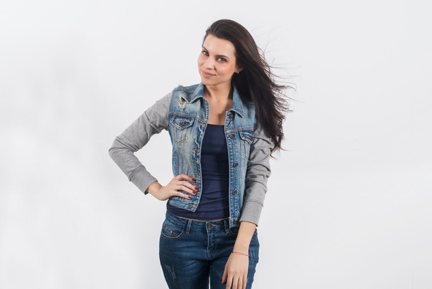 woman posing in jeans on white wall - Foto, Imagem