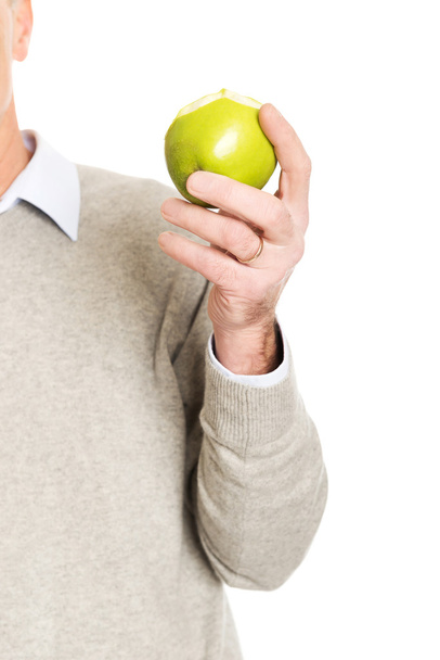 Close up on male hand holding an apple - Fotó, kép