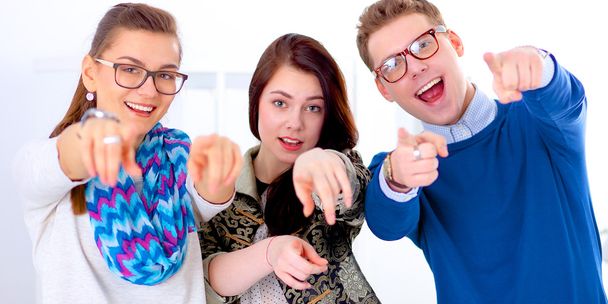 Young business people standing at office near desk and pointing you - Fotoğraf, Görsel