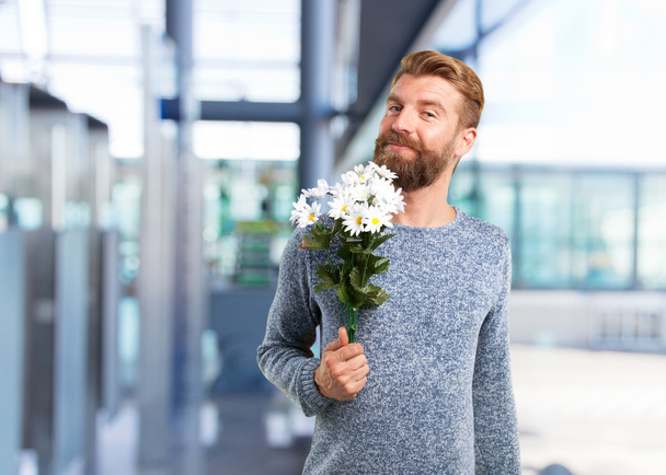 blonde man with a bouquet of flowers - 写真・画像