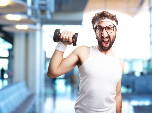 young crazy sportsman with dumbbell - Foto, Imagen