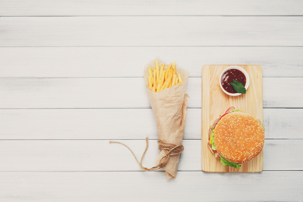 Burger, chips and ketchup at white wood - Fotoğraf, Görsel