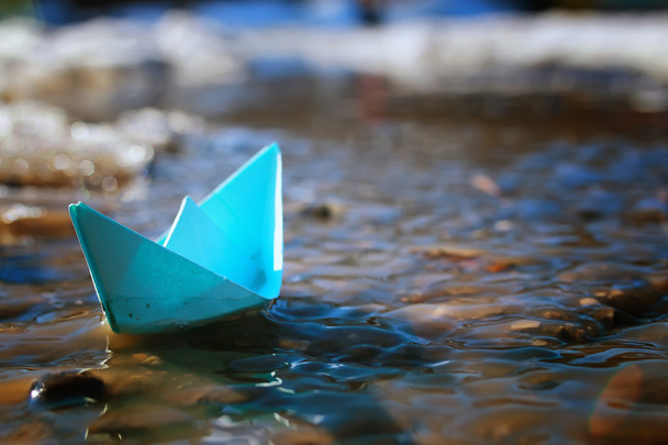 tinted photo paper boat on spring street - Photo, Image