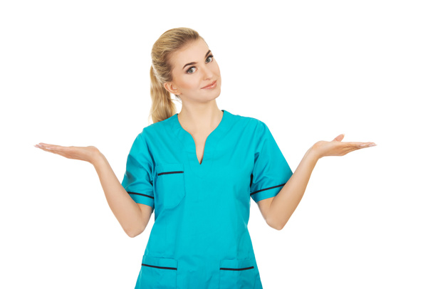 Smiling woman doctor or nurse pointing something - Foto, Bild