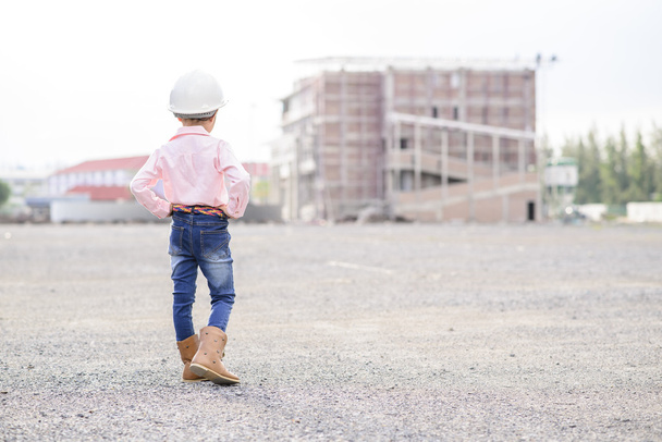 Litte civil engineer girl inspecting the building in construction site with pose - Φωτογραφία, εικόνα