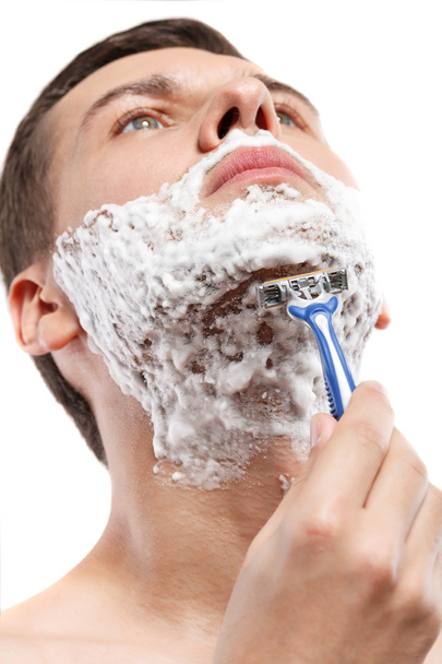 Attractive young guy is shaving in morning - Fotografie, Obrázek