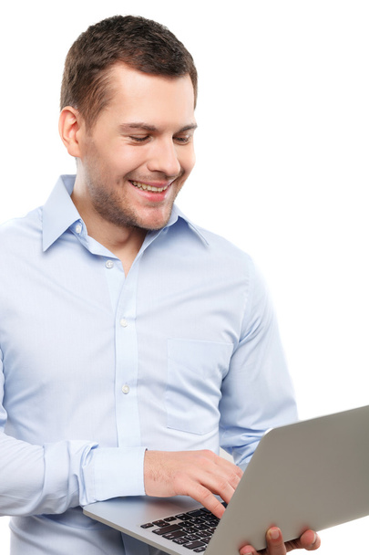 Attractive male worker is using a computer - Photo, image