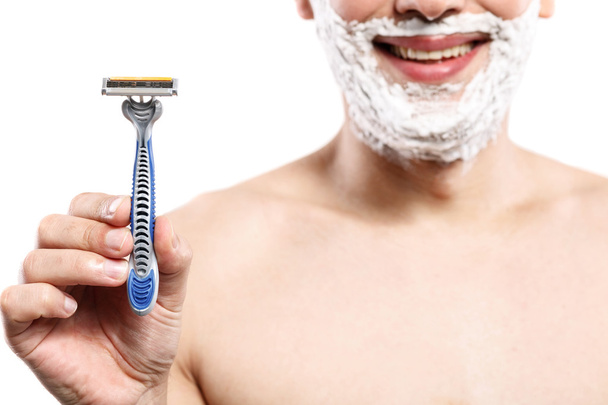 Cheerful young guy is ready to shave - 写真・画像
