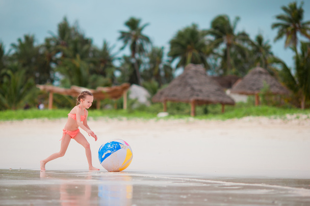 Küçük kız beyaz kumsalda büyük hava topla oynamayı - Fotoğraf, Görsel