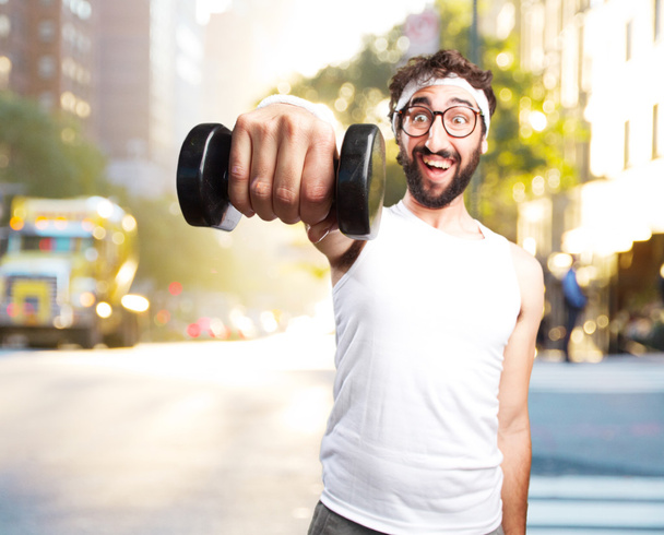 young crazy sportsman with dumbbell - Fotoğraf, Görsel