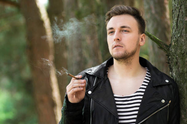 Smoking guy with a cigarette - Φωτογραφία, εικόνα