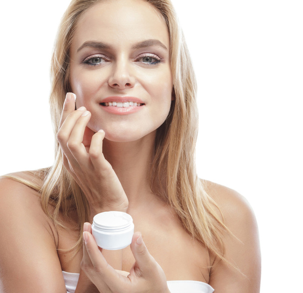 woman applying facial cream  - Фото, изображение