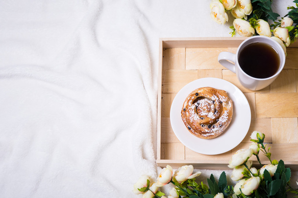 good morning - breakfast with bun and tea on wooden tray and flo - Valokuva, kuva