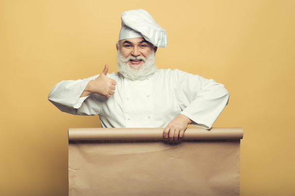 Chef man with empty paper - Фото, изображение