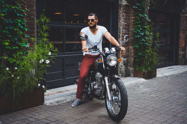 young guy posing sitting on motorcycle - Fotoğraf, Görsel