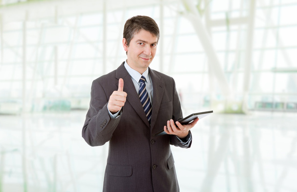 бізнесмен йде пальцями вгору за допомогою планшетного ПК, в офісі
 - Фото, зображення