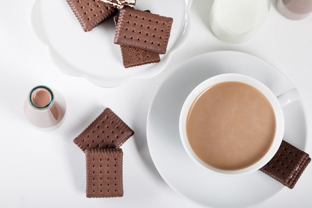 Kopje koffie en enkele flessen melk en chocolade milkshakes f - Foto, afbeelding