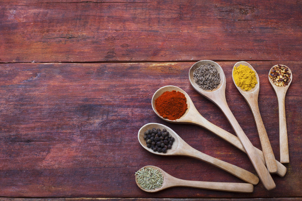 Wooden spoons full of herbs and spices - Photo, Image