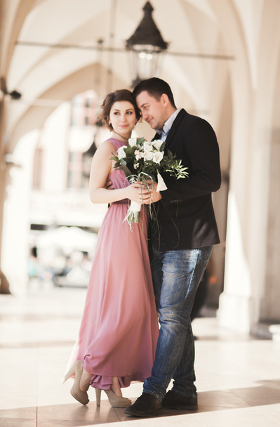 Romantic wedding couple, man and wife, posing near old building column - Foto, immagini