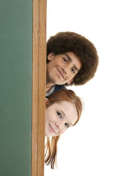 Smiling teens with blank chalkboard - Foto, Imagen