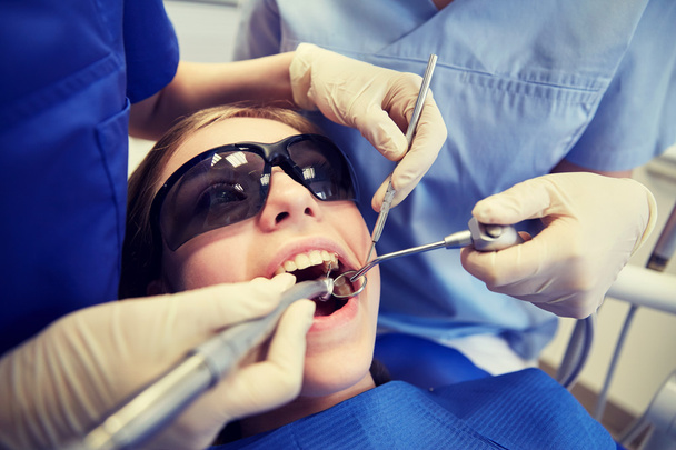 female dentists treating patient girl teeth - 写真・画像