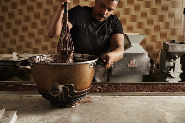 chief mix melted chocolate in special pot  - Zdjęcie, obraz
