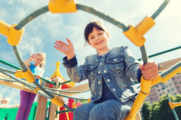 happy little girl climbing on children playground - Fotoğraf, Görsel