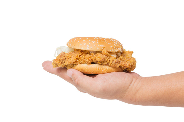 Hand holding a fried chicken burger isolate on white - Fotó, kép