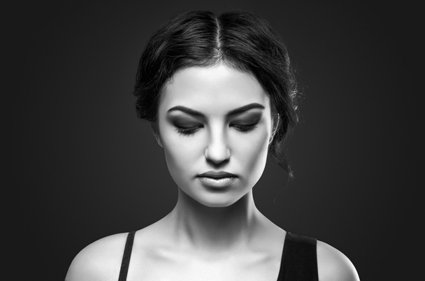 Portrait of beautiful female model on gray background - Foto, imagen