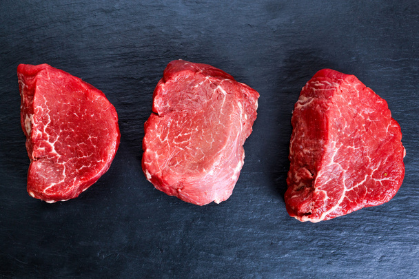Fresh Raw Beef steak Mignon on blue dark board background, - Zdjęcie, obraz