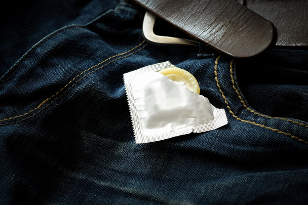 Kondomi sinisissä farkuissa. Keskity kondomiin
. - Valokuva, kuva