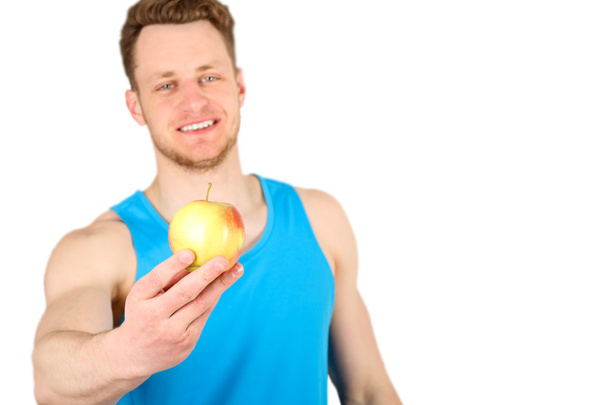 リンゴを与える腕を持つ筋肉男 - 写真・画像
