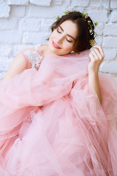 Bride in a tender light pink wedding dress in a morning. Fashion beauty portrait - Fotó, kép