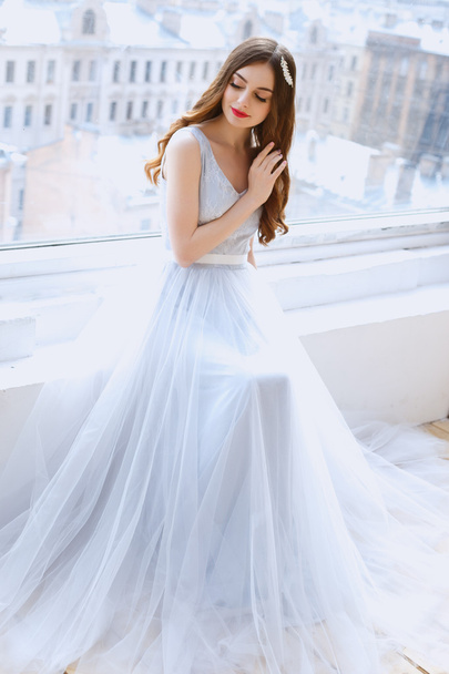 Bride in a tender light blue wedding dress in a morning. Fashion beauty portrait - 写真・画像