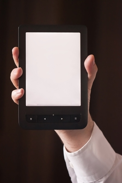 An ebook reader in a hand - Photo, Image