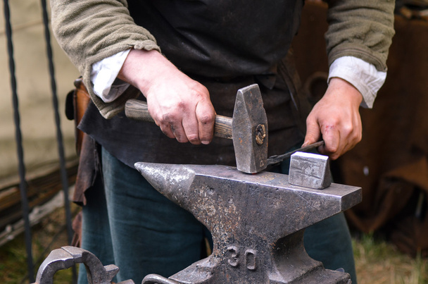 Кузнец, работающий над металлическим средневековьем
 - Фото, изображение