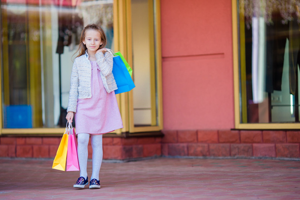 Adorable little girl shopping in the city outdoors - Photo, Image