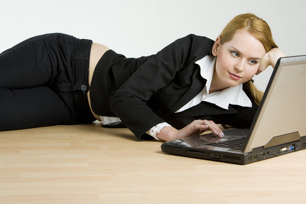 Lying businesswoman with a notebook - Фото, зображення