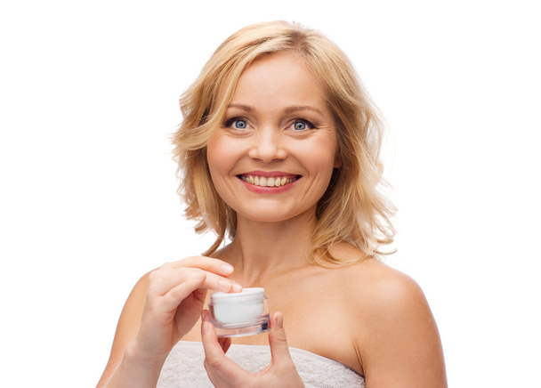 happy woman with cream jar - Фото, изображение