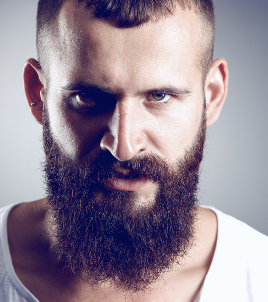 Portrait of handsome bearded man standing, isolated on grey background - Foto, Imagem