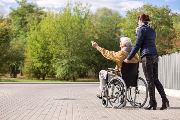Disabled man and female caregiver - Foto, imagen