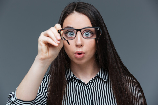 Funny woman holding glasses  - Фото, изображение