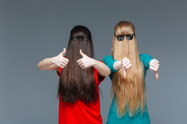 Two comical women with faces covered by long hair gesturing - Photo, Image