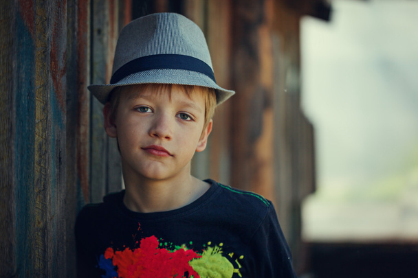 Young attractive boy wearing a hat, looking at the camera. - 写真・画像