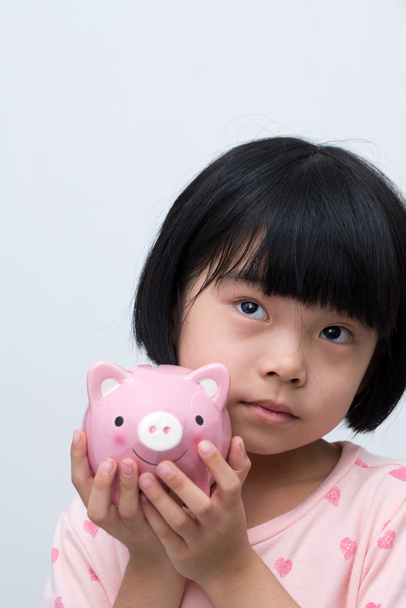 Asian child with piggy bank - Photo, Image