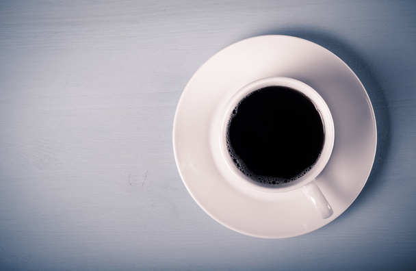 White cup of tea on blue wooden table. Toned - Fotó, kép