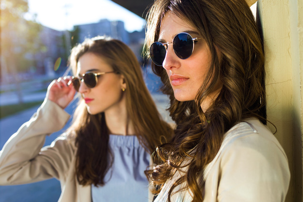Two beautiful young women posing in the street. - Fotó, kép