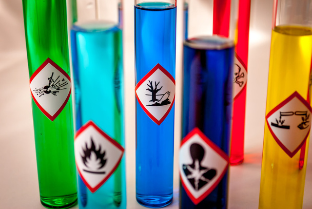 Multicolored Chemistry vials - Focus on hazardous to the environment danger - Photo, Image